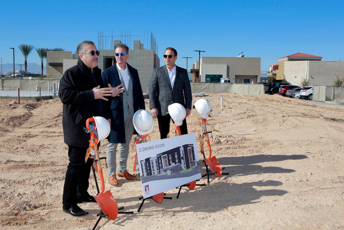 eter Guzman of the Latin Chamber of Commerce speaks to the attendees alongside Todd Nigro and Michael Nigro of Nigro Construction during a ground breaking ceremony