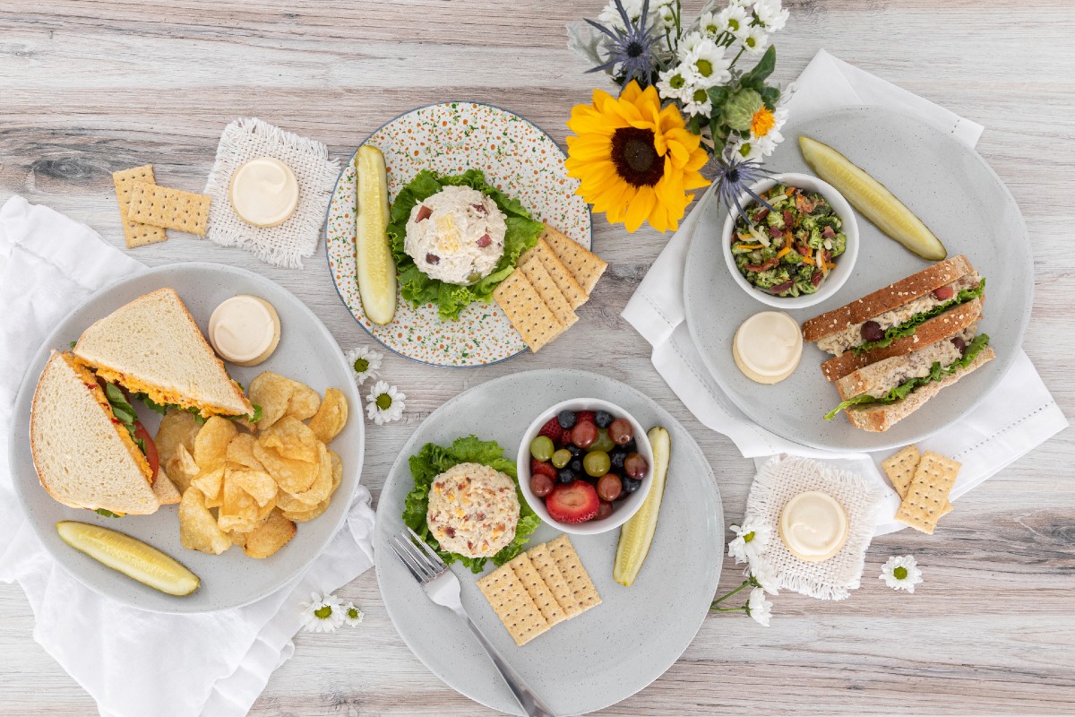 Chicken Salad Chick plated sandwiches and scoops with sides.