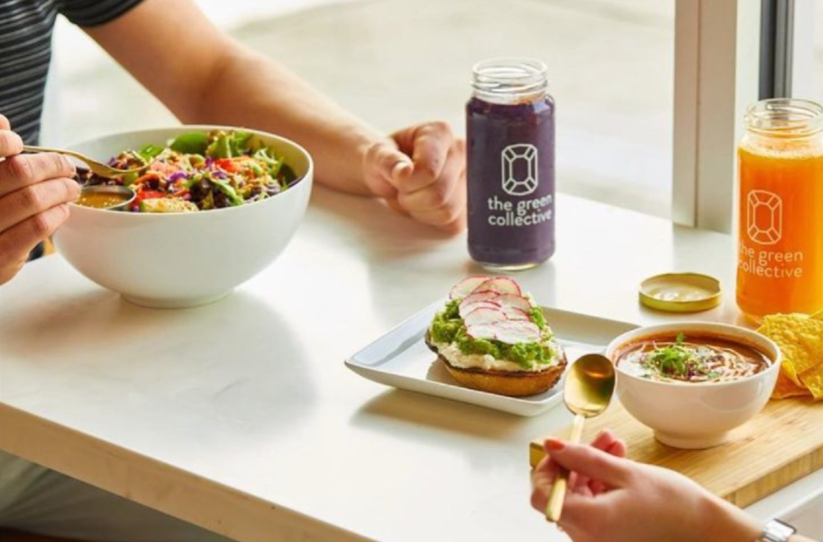 The Green Collective eatery bowls, toasts and smoothies at a customer table.