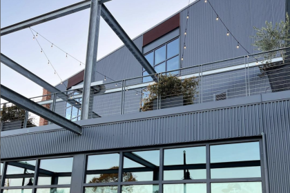 The external view of the Cleats building in Charleston, with large branded windows and a rooftop deck.