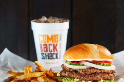 A burger with a milkshake and fries