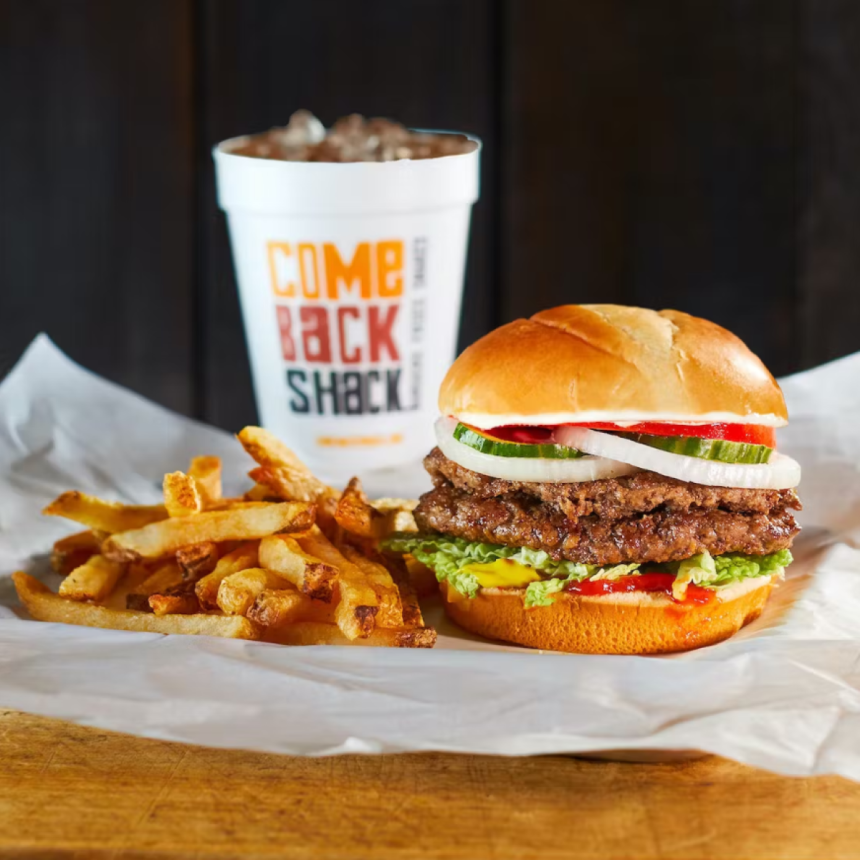 A burger with a milkshake and fries