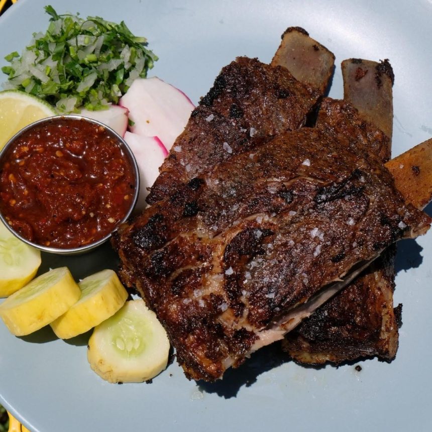 An image of CARNITAS RIBS prepared at new restaurant Colectivo in charleston, along with salsa, squash and radish