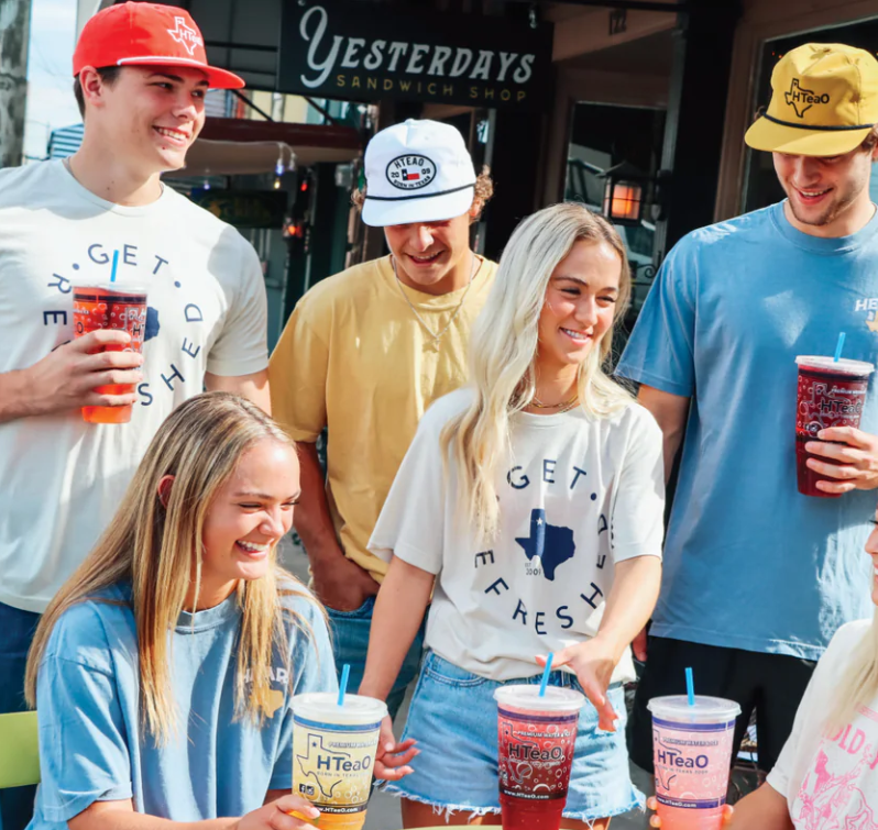 A group of young people wearing HTeaO merchandise and drinking iced teas which will be sold at the new Charleston location soon