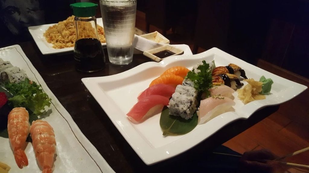 The menu highlights include the Godzilla roll, spicy crab, eel avocado roll, etc. 