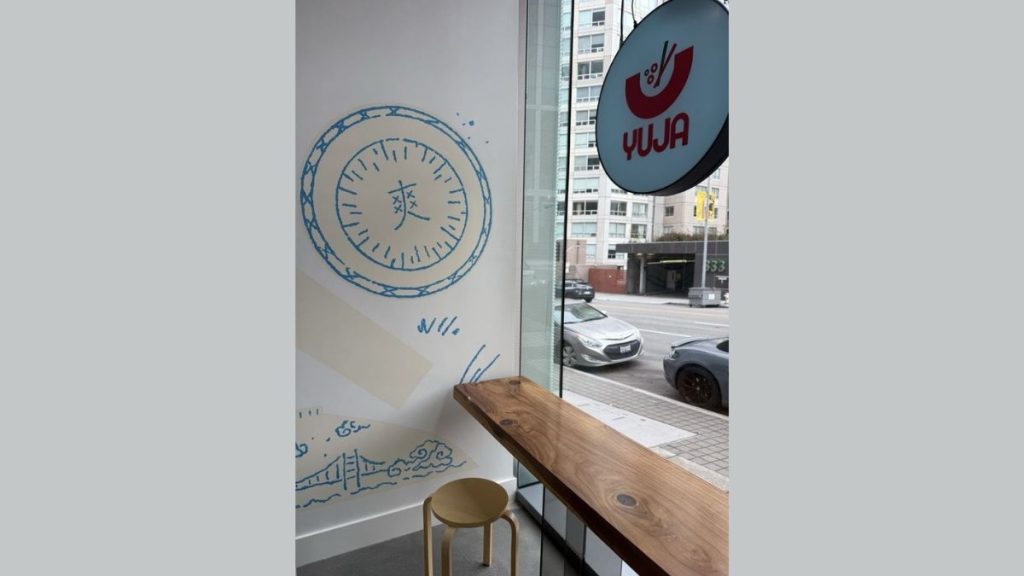 A shot from inside of Yuja Kitchen, an outdoor-facing table for guests