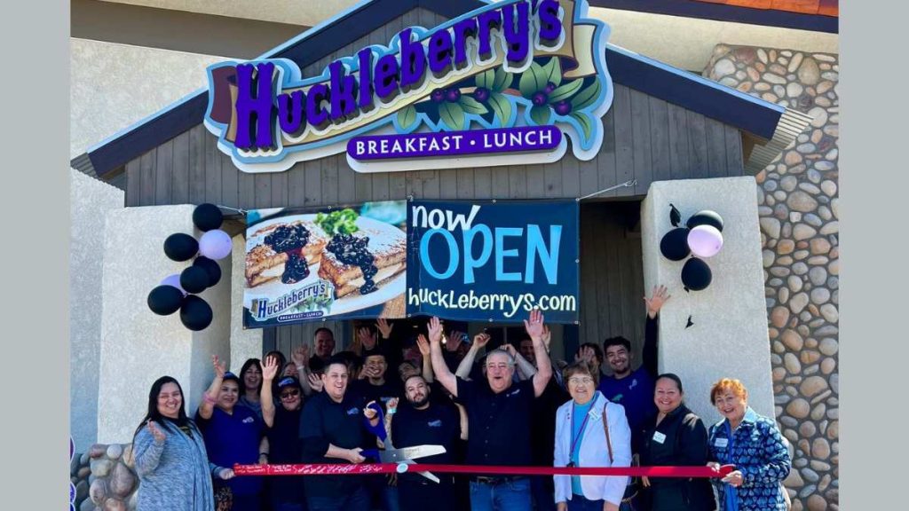 This image shows employees celebrating the opening of Huckleberry’s Breakfast and Lunch.