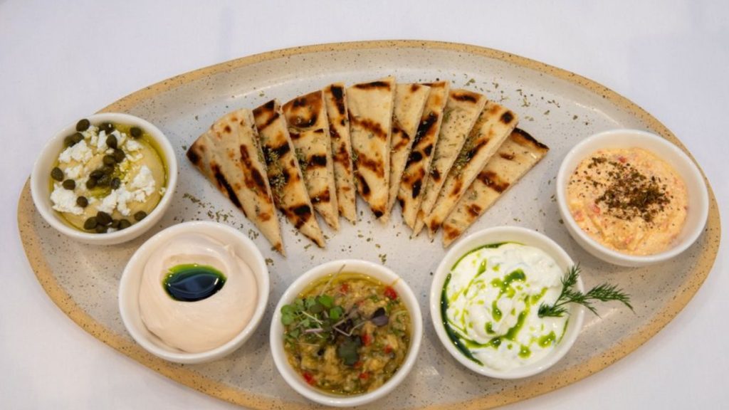 Depiction of a food plate from Delos Greek Restaurant (Source: Yelp by Delos Greek Restaurant)