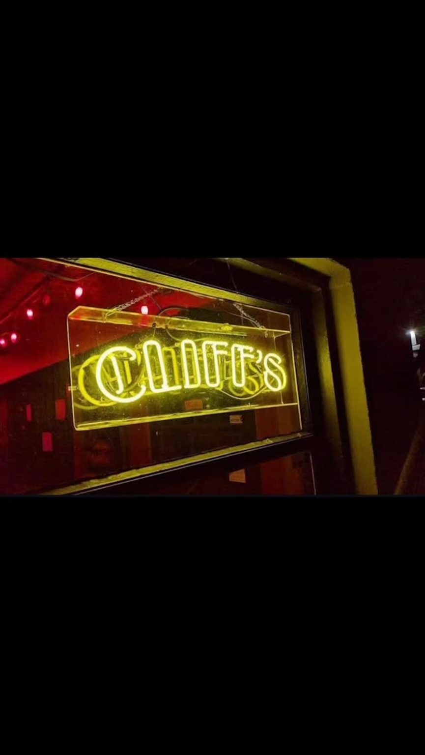 Lit-up sign that says Cliffs in neon yellow