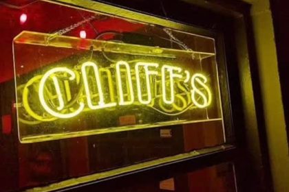 Lit-up sign that says Cliffs in neon yellow