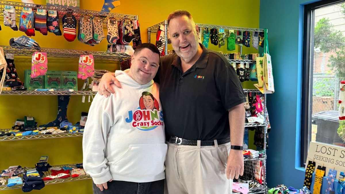 John Cronin and his father pose for a picture at the new store