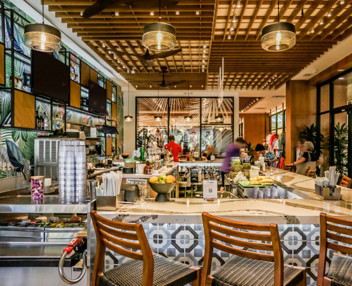 Known for tropical cocktails, seafood-forward bites, and "toes in the sand" vibes